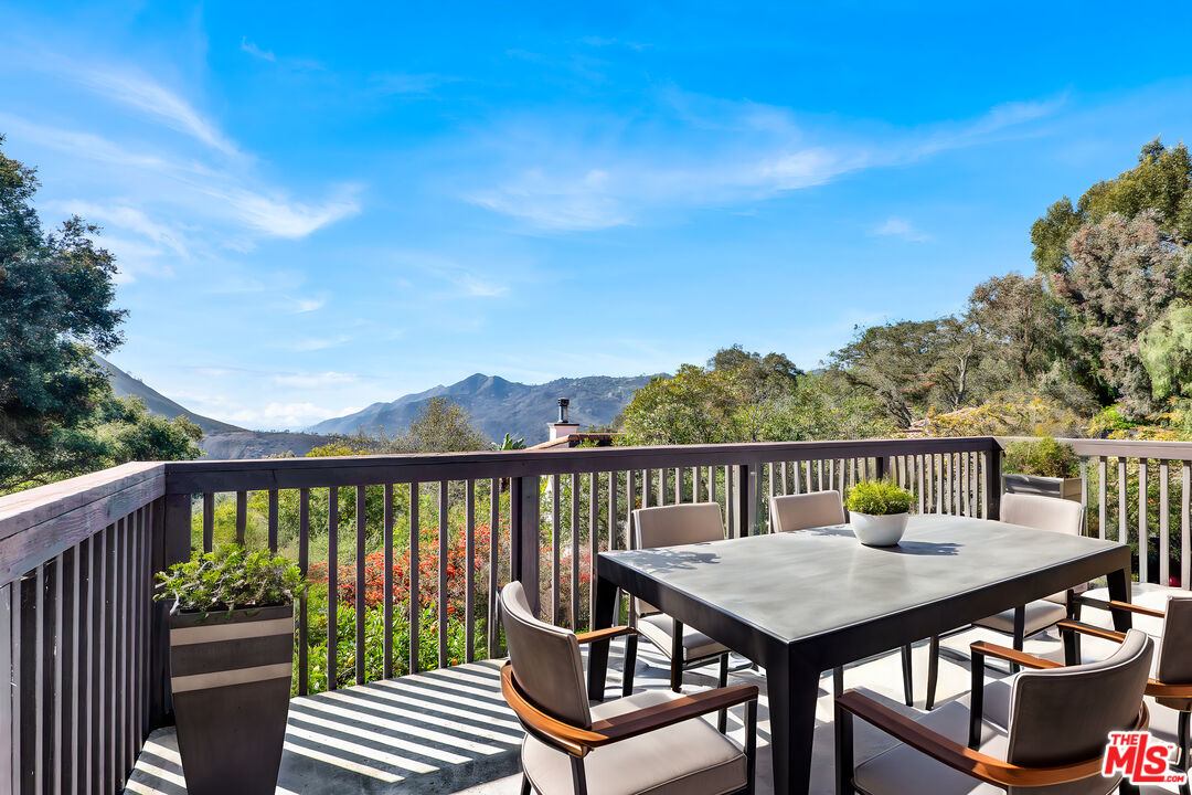 20948 Waveview Drive Topanga, CA 90290 - Photo 1 of 19 a view of a balcony with wooden floor and outdoor seating