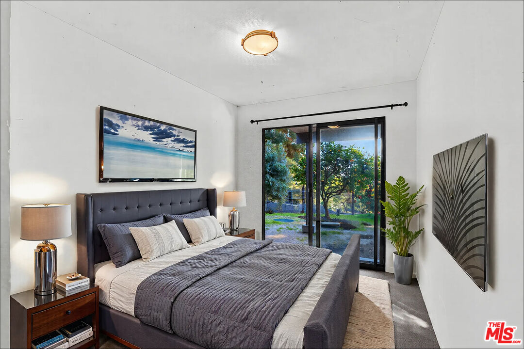 20948 Waveview Drive Topanga, CA 90290 - Photo 12 of 19 a bedroom with a large bed and a window