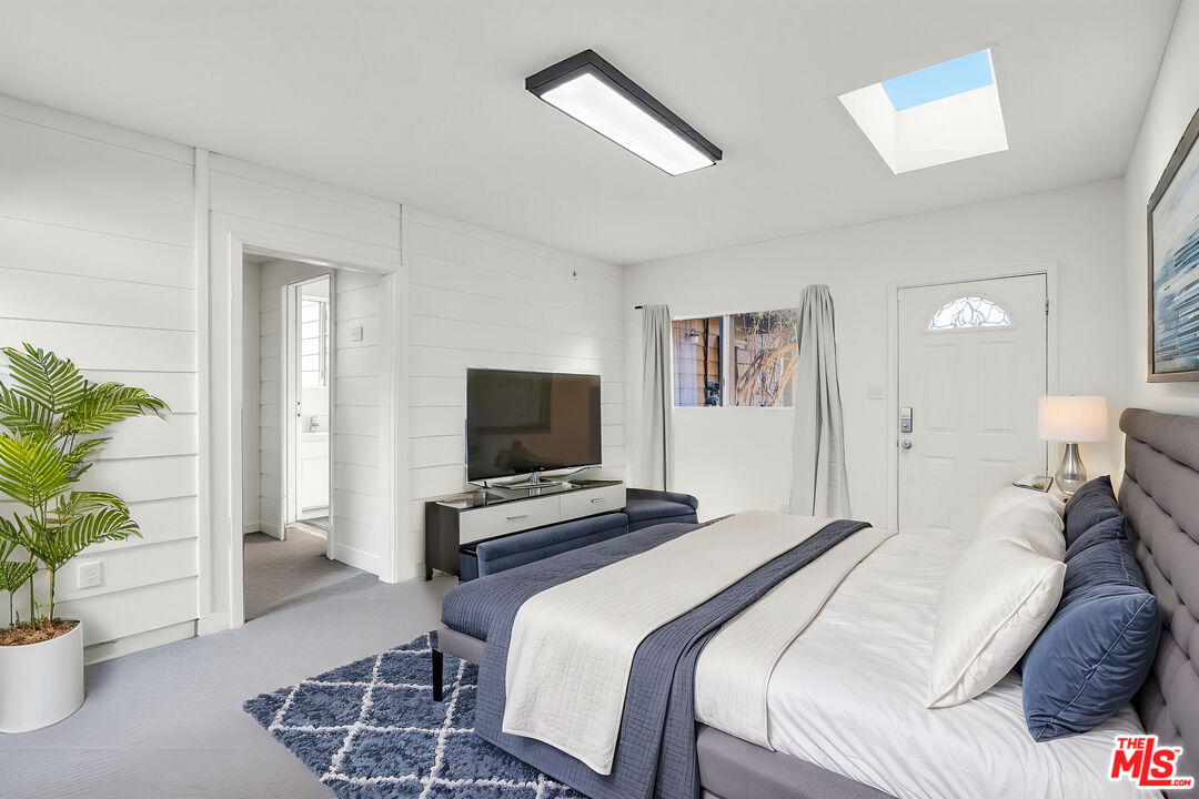 20948 Waveview Drive Topanga, CA 90290 - Photo 13 of 19 a bedroom with a bed and a television