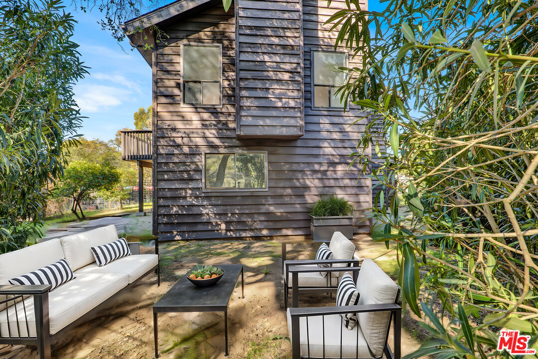 20948 Waveview Drive Topanga, CA 90290 - Photo 17 of 19 a view of a chairs and table in the back yard of the house