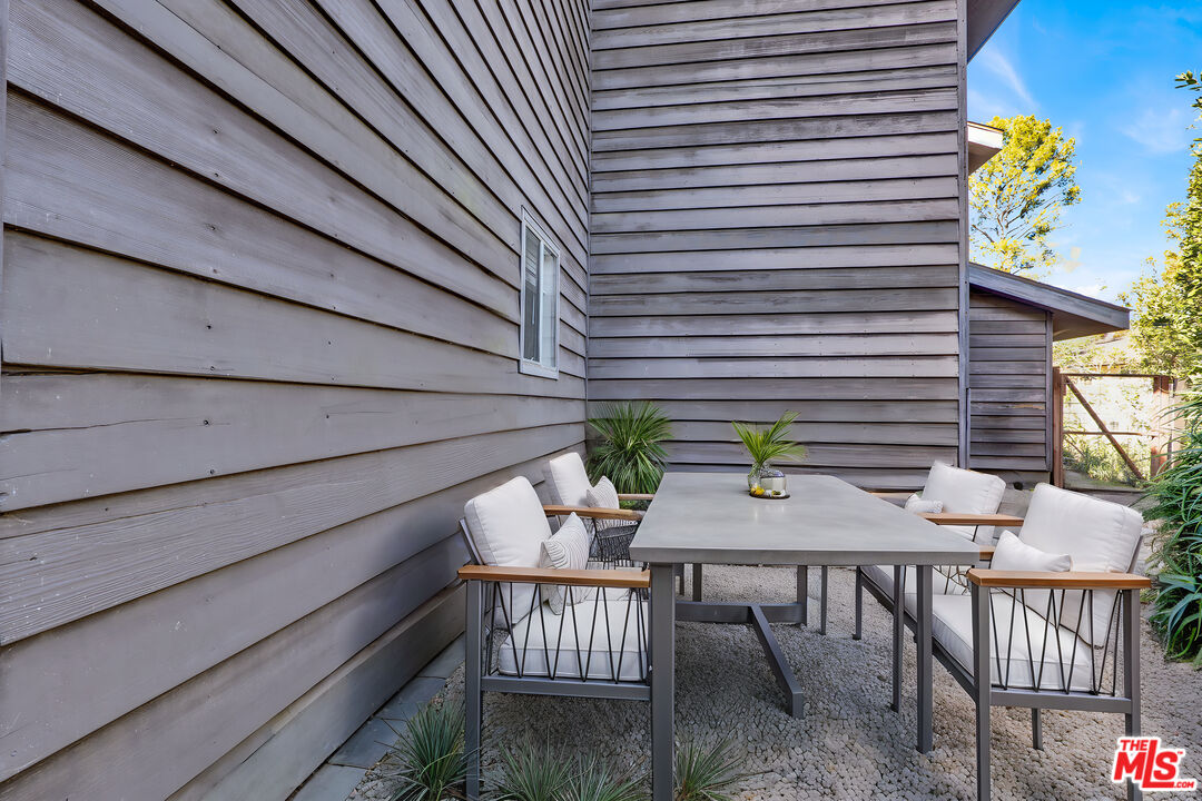 20948 Waveview Drive Topanga, CA 90290 - Photo 18 of 19 a view of a patio with table and chairs and wooden floor