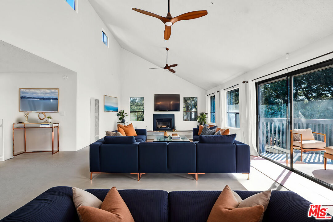 20948 Waveview Drive Topanga, CA 90290 - Photo 4 of 19 a living room with furniture a flat screen tv and floor to ceiling window