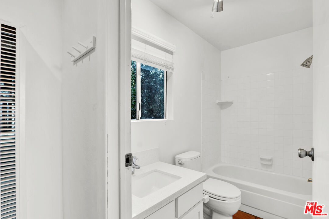 20948 Waveview Drive Topanga, CA 90290 - Photo 10 of 19 a bathroom with a bathtub shower sink vanity and toilet