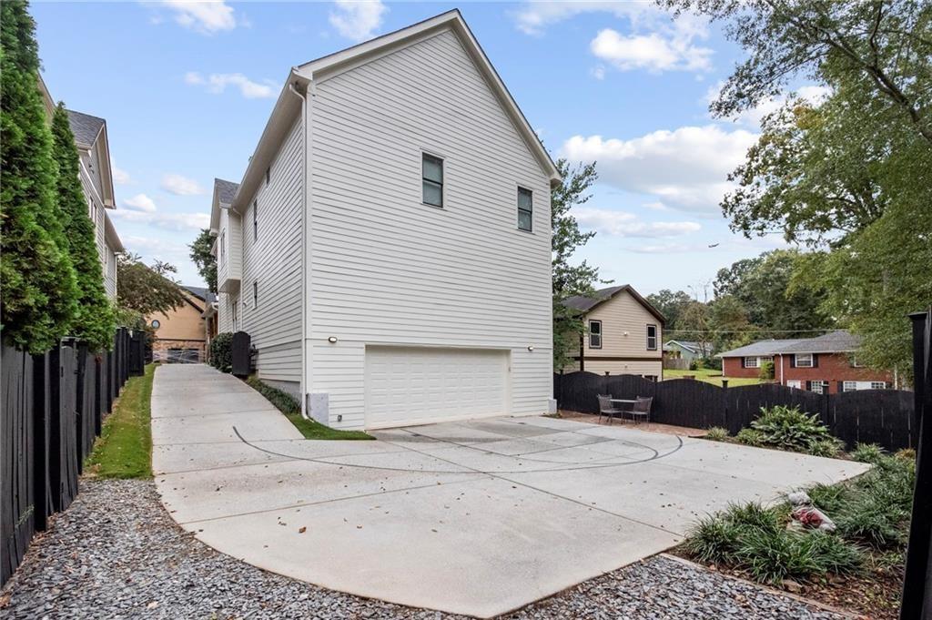 3433 Pierce Street Atlanta, GA 30337 - Photo 35 of 42 a view of a white house with a sink and yard