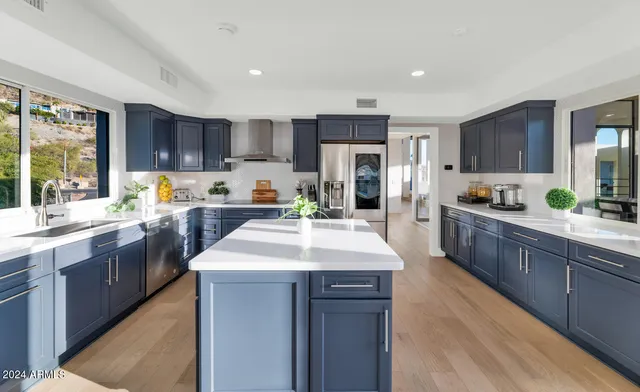 a kitchen with a sink stove cabinets and refrigerator