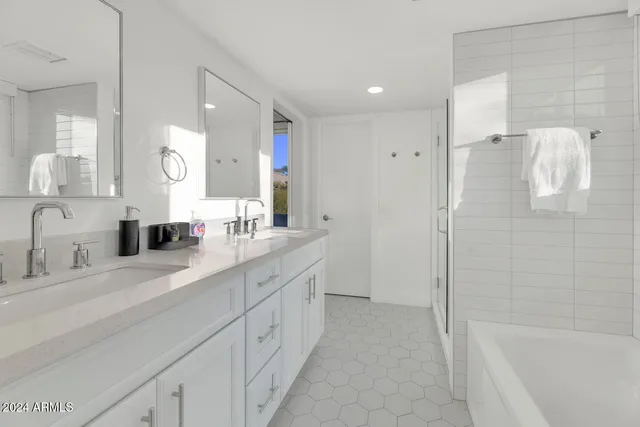 a spacious bathroom with a double vanity sink mirror double and bathtub