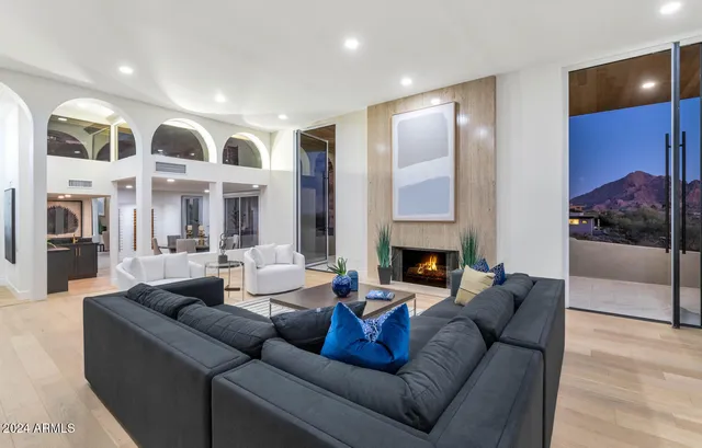a living room with furniture and a fireplace