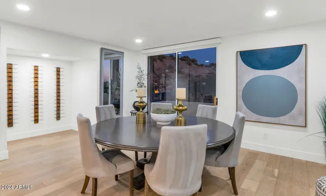 a dining room with furniture and wooden floor
