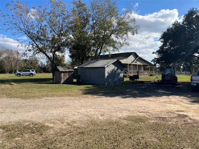 a front view of house with yard and car parked