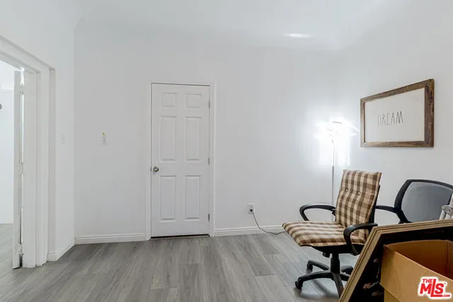 a view of a workspace with furniture and wooden floor