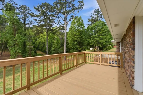 a view of balcony with deck and trees