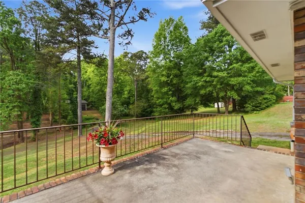 a view of a park with iron fence