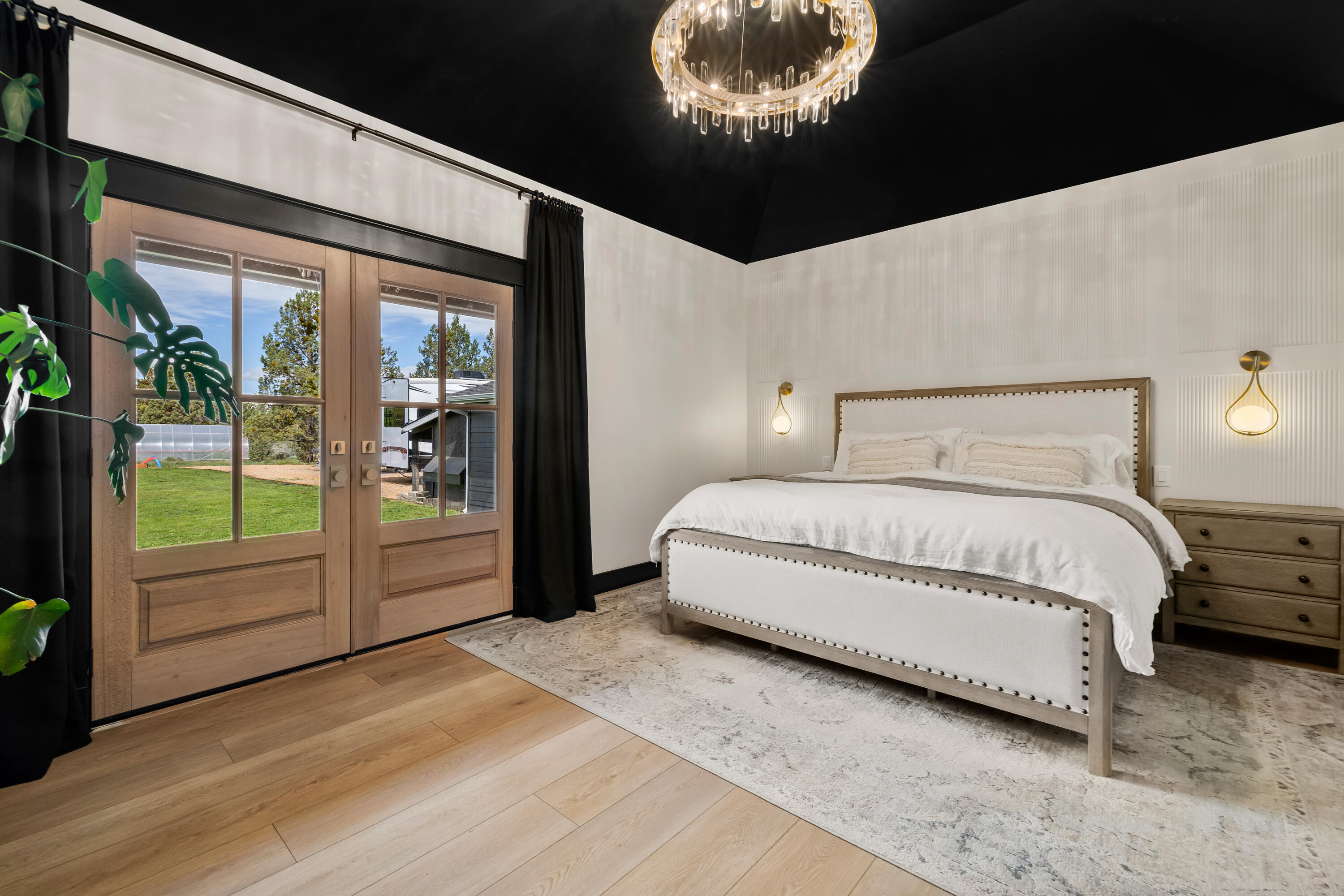62705 Hamby Road Bend, OR 97701 - Photo 18 of 49 a spacious bedroom with a bed and glass door