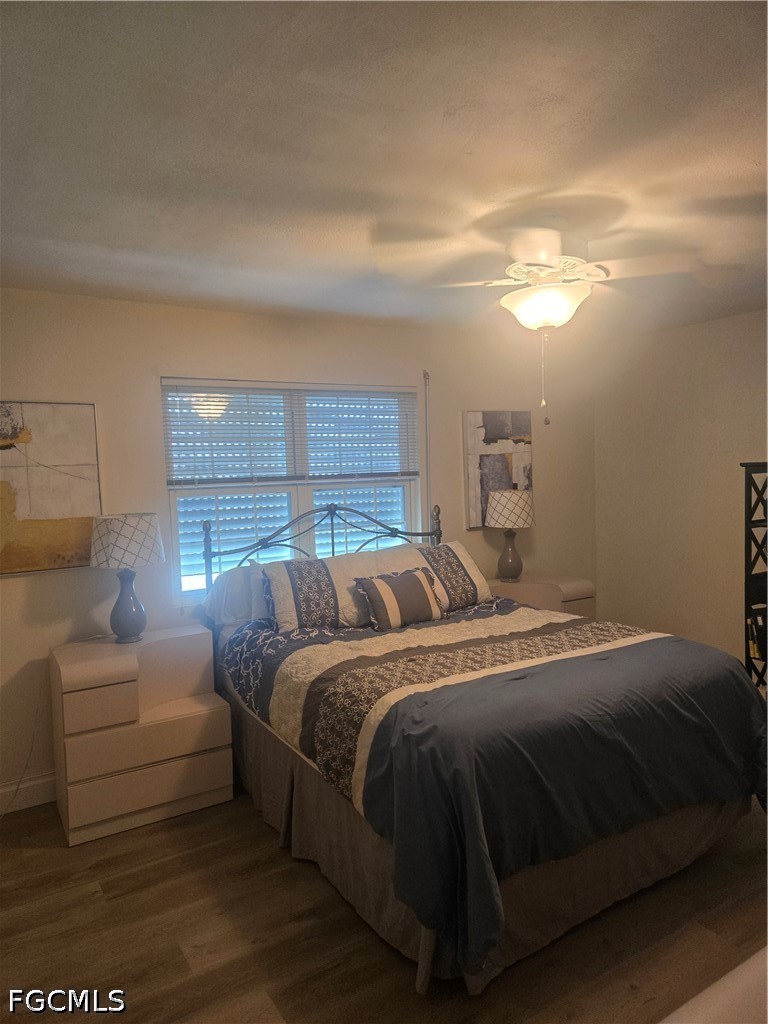 8093 Anhinga Road Fort Myers, FL 33967 - Photo 26 of 49 a bedroom with a bed and a night stand