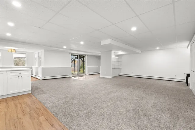 a view of an empty room with a kitchen