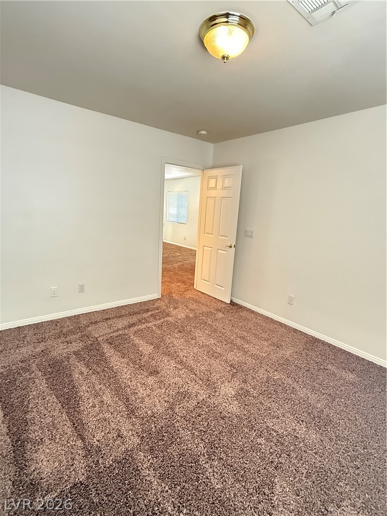 10975 Calcedonian Street Las Vegas, NV 89141 - Photo 15 of 25 Step into this comfortable space featuring soft carpet flooring, perfect for cozy living.