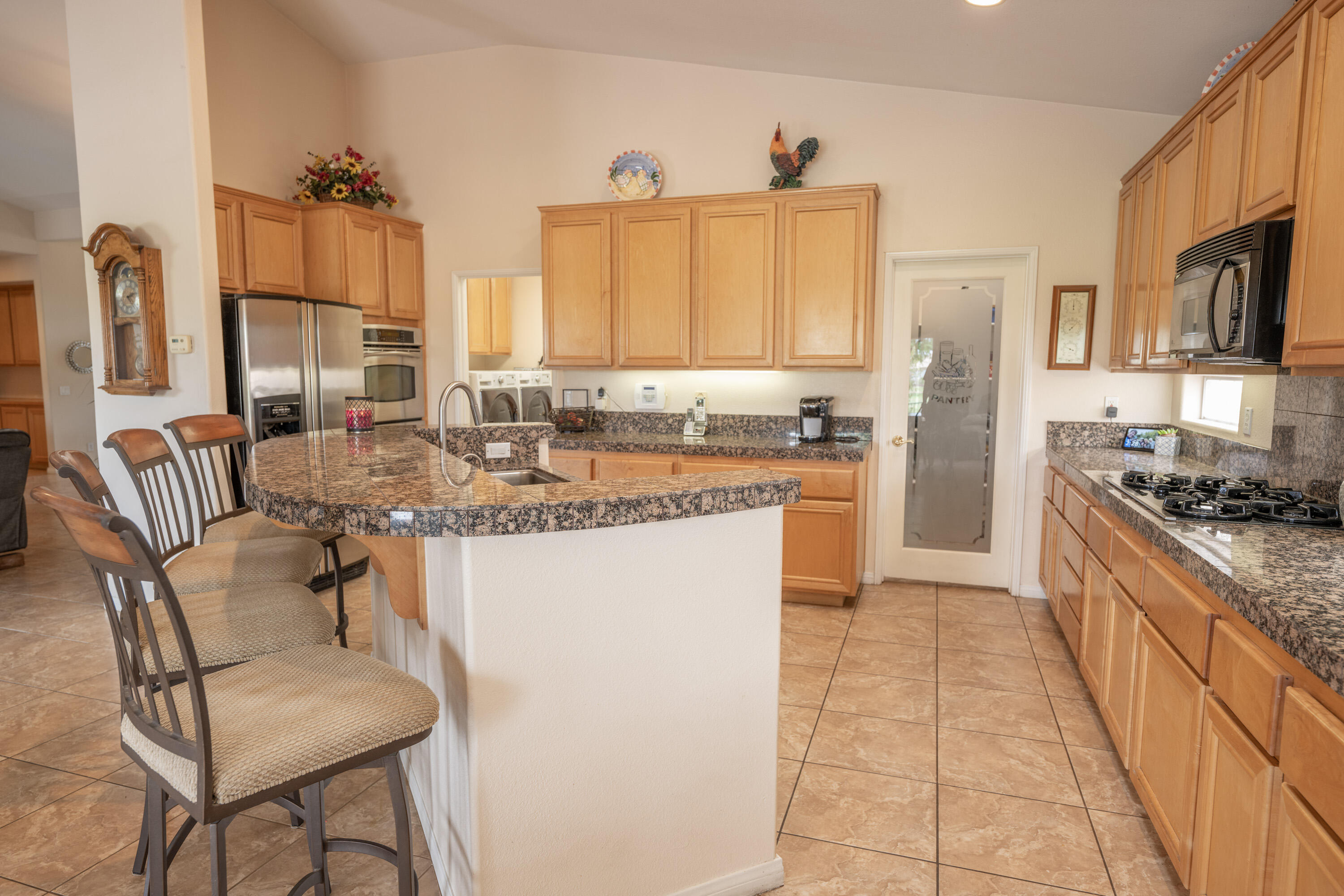 80307 Green Hills Drive Indio, CA 92201 - Photo 17 of 48 a kitchen with stainless steel appliances granite countertop a sink and a refrigerator