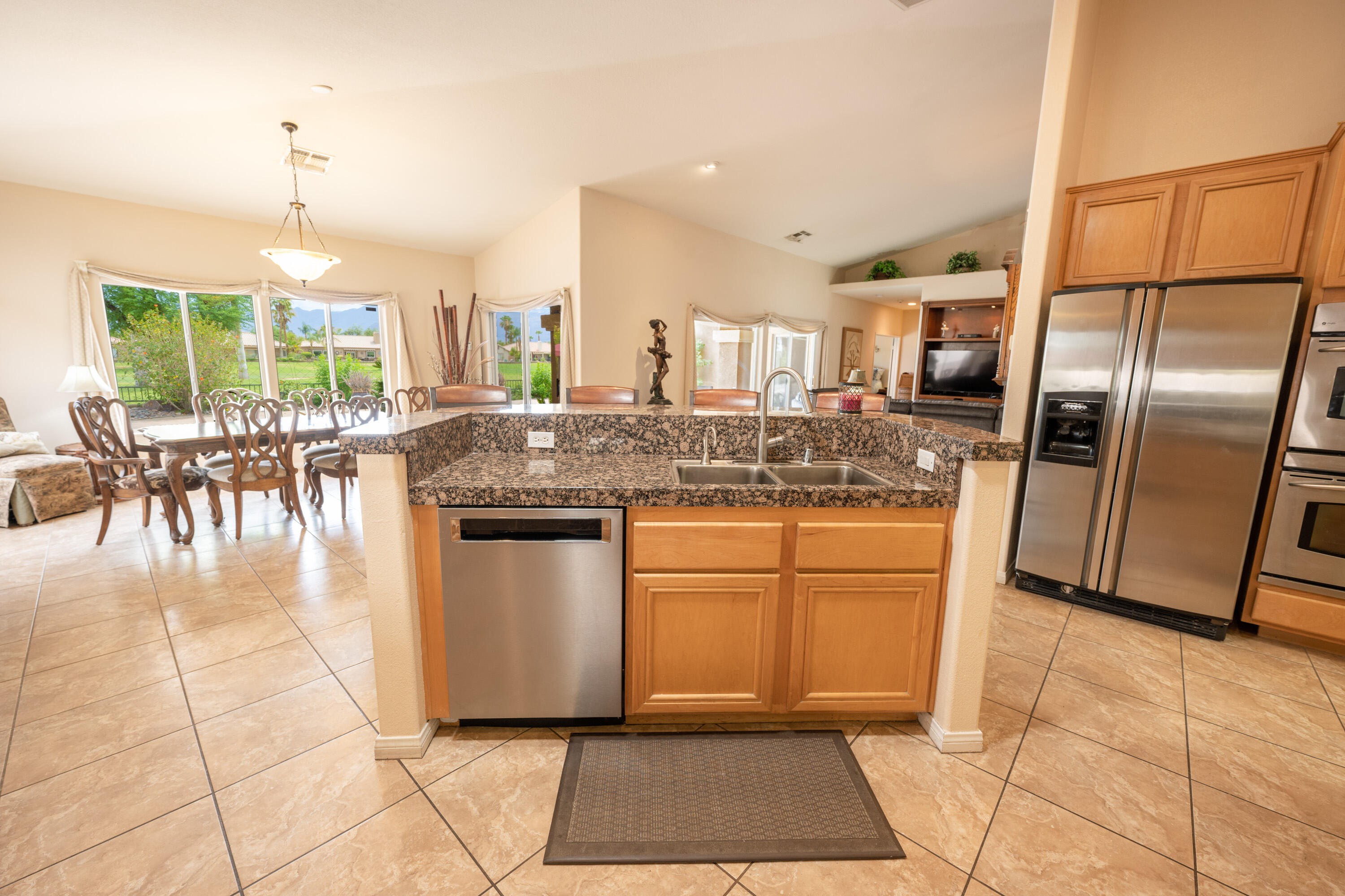 80307 Green Hills Drive Indio, CA 92201 - Photo 20 of 48 a kitchen with stainless steel appliances granite countertop a stove a sink a microwave and dining table