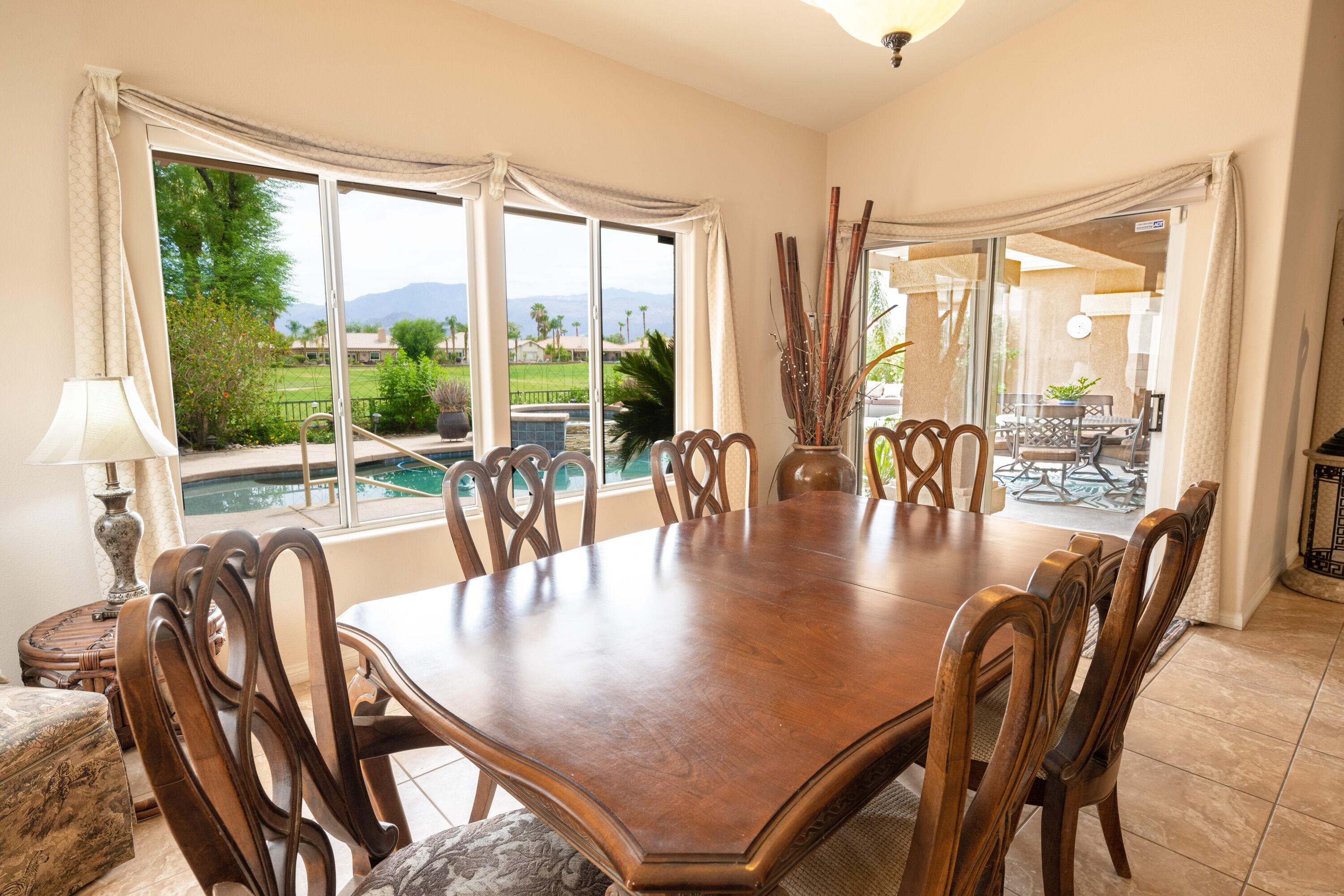 80307 Green Hills Drive Indio, CA 92201 - Photo 21 of 48 a dining room with furniture wooden floor and a chandelier