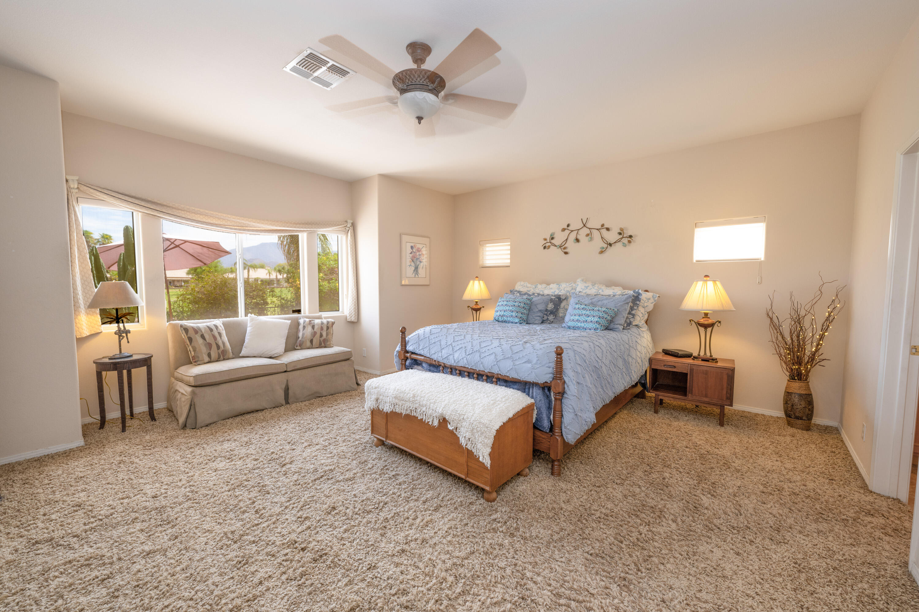 80307 Green Hills Drive Indio, CA 92201 - Photo 22 of 48 a spacious bedroom with a bed and a couch