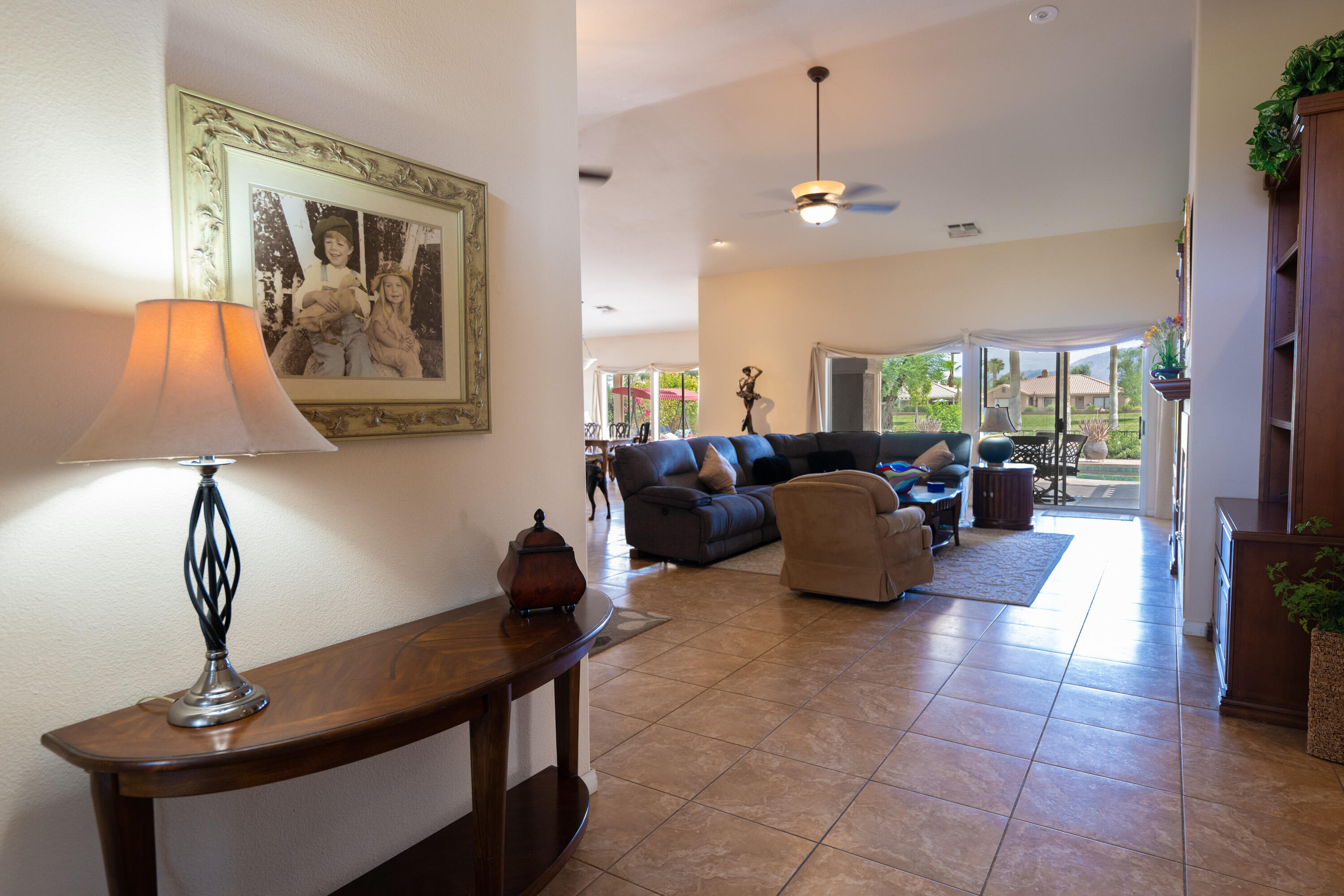 80307 Green Hills Drive Indio, CA 92201 - Photo 30 of 48 a living room with furniture and a chandelier