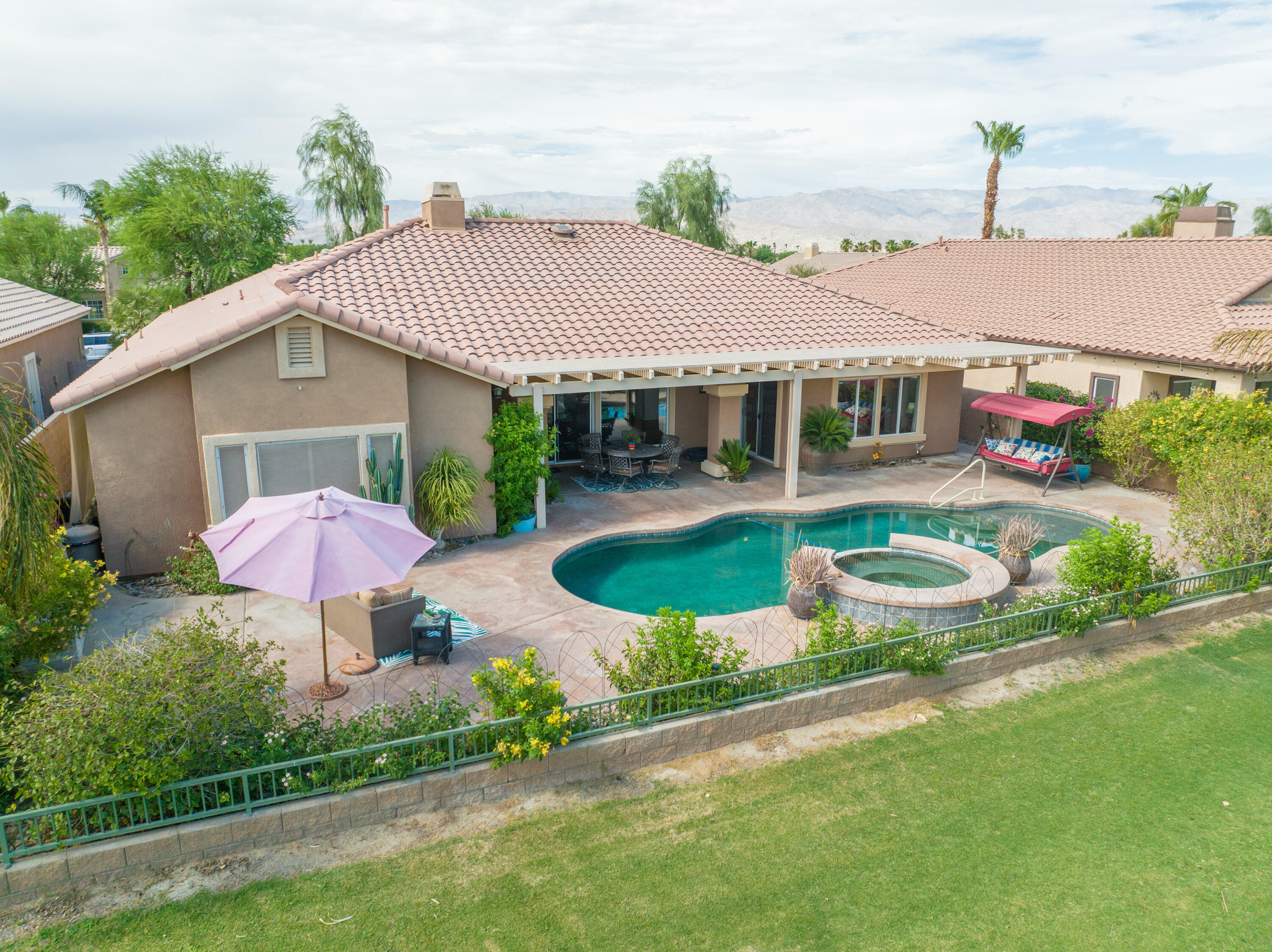 80307 Green Hills Drive Indio, CA 92201 - Photo 3 of 48 a front view of a house with garden