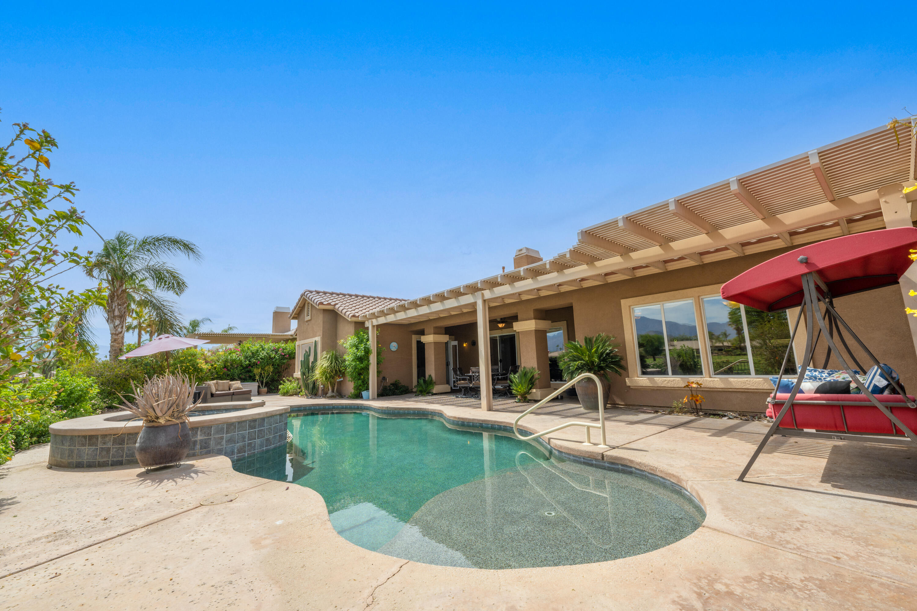 80307 Green Hills Drive Indio, CA 92201 - Photo 32 of 48 a view of a house with swimming pool and sitting area