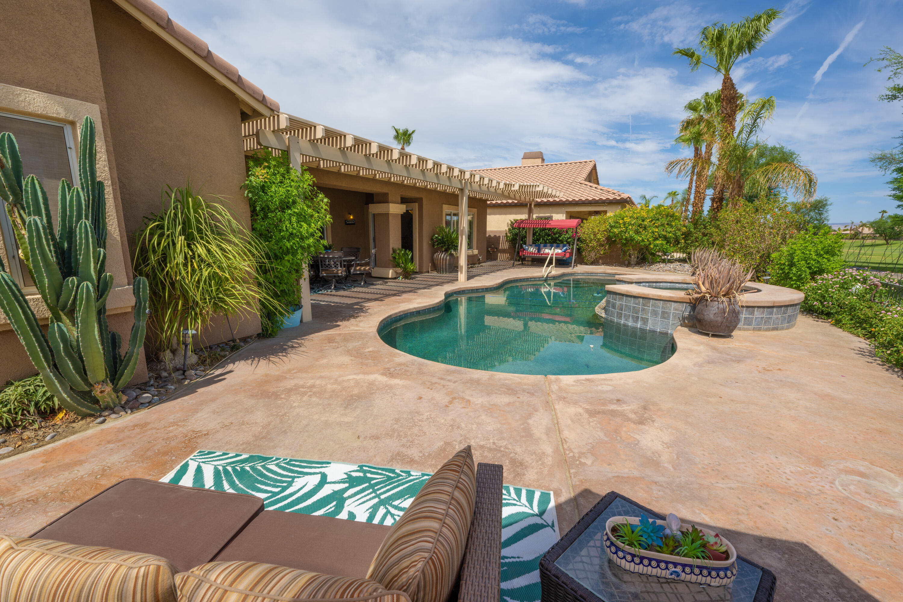 80307 Green Hills Drive Indio, CA 92201 - Photo 33 of 48 a view of a patio with couches chair and potted plants