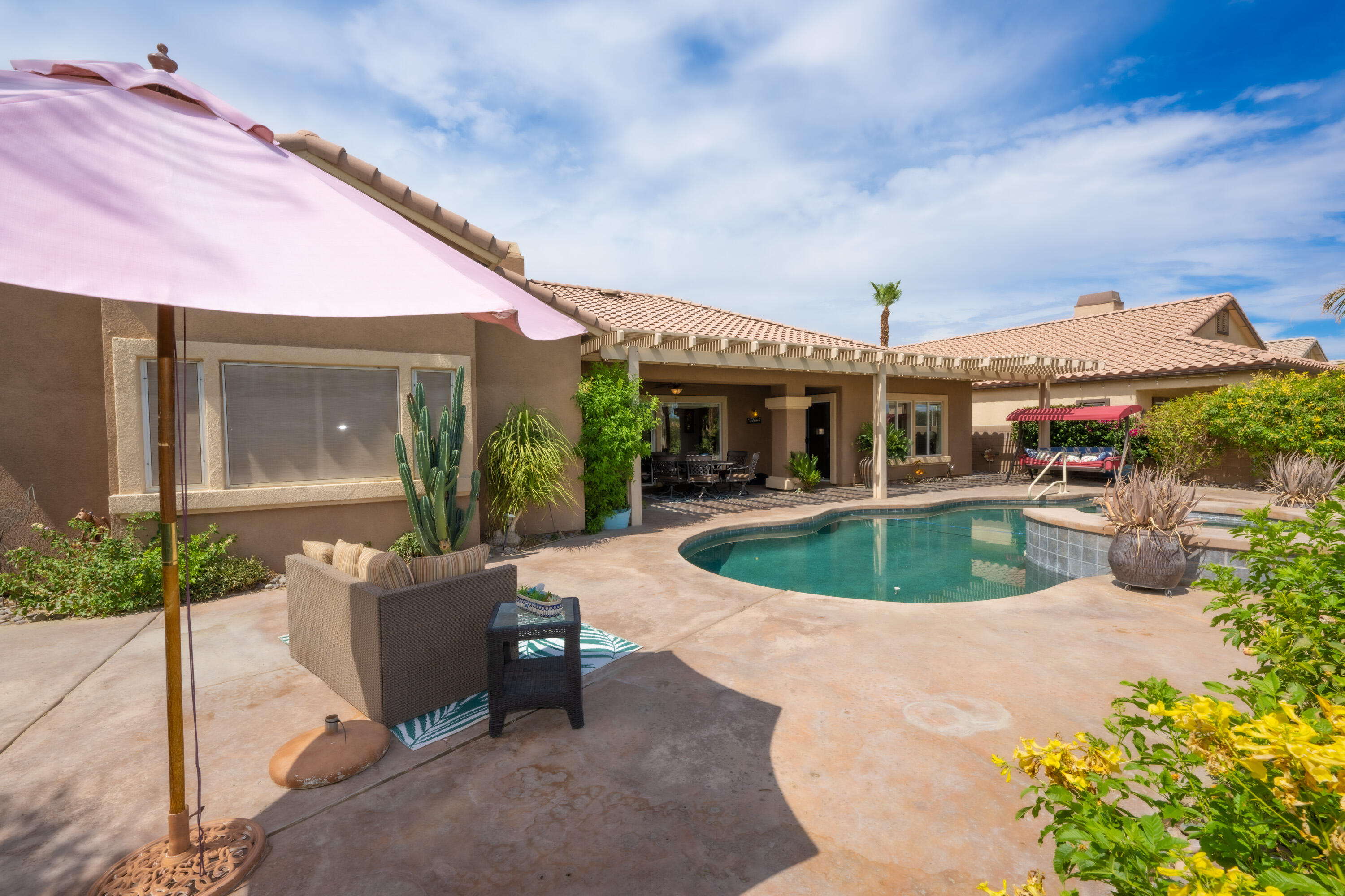 80307 Green Hills Drive Indio, CA 92201 - Photo 6 of 48 a view of a house with backyard porch and sitting area