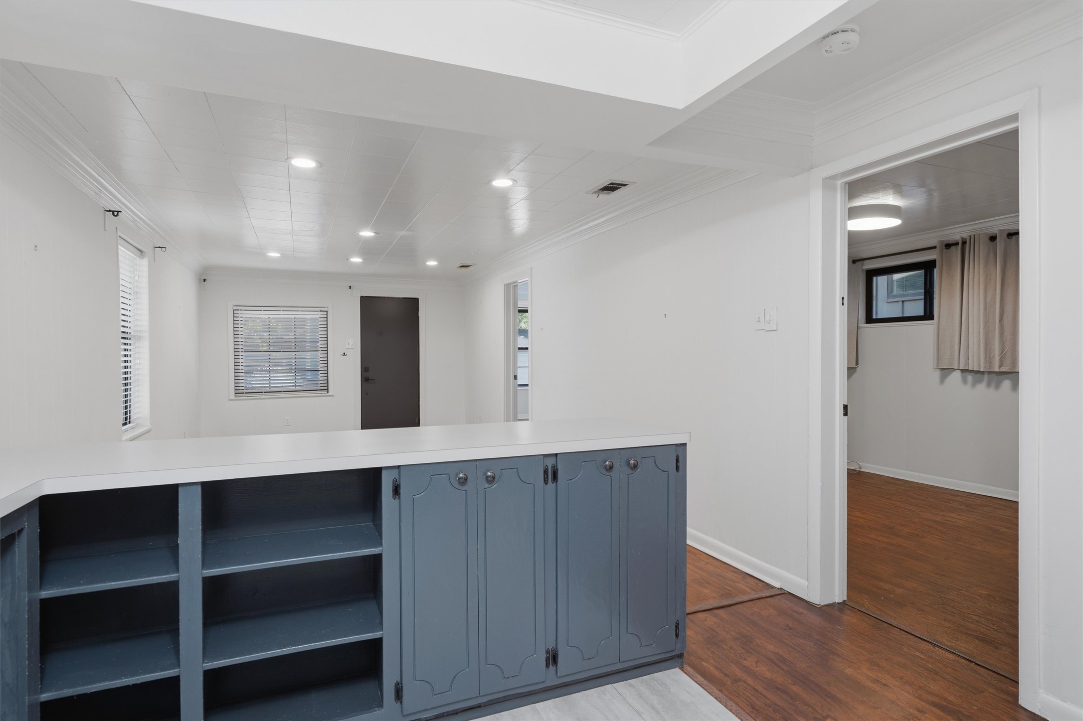 2204 Santa Rita Street Austin, TX 78702 - Photo 23 of 23 Recessed lighting illuminates this versatile floor plan featuring custom built-ins and rich wood flooring.