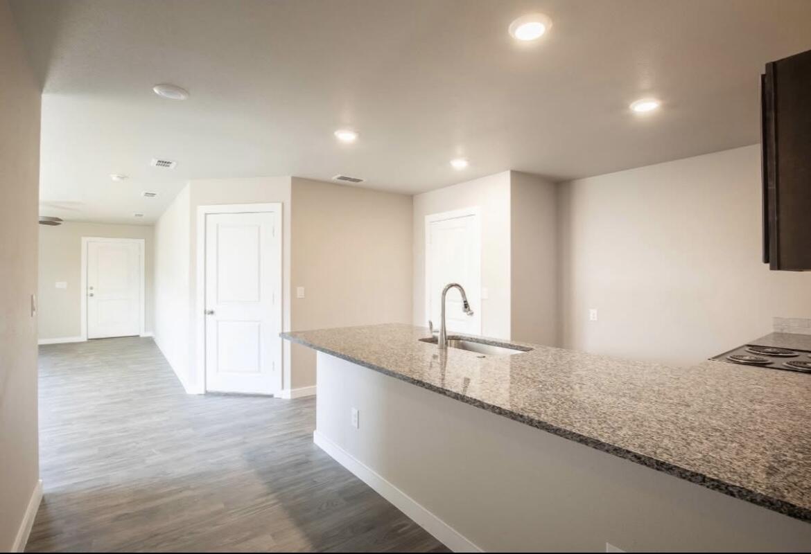 14403 Avenue X, Unit B Lubbock, TX 79423 - Photo 4 of 13 a large kitchen with stainless steel appliances granite countertop a sink and a granite counter tops