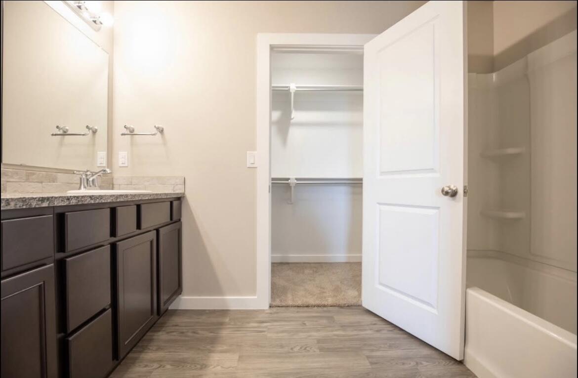 14403 Avenue X, Unit B Lubbock, TX 79423 - Photo 8 of 13 a bathroom with a sink and a mirror