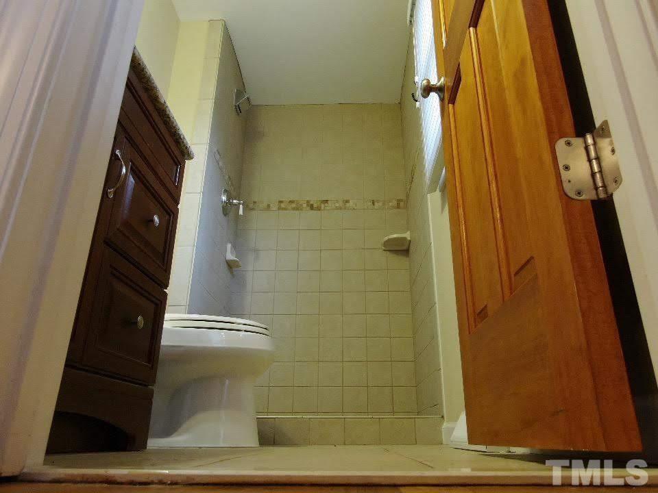 4703 Latimer Road Raleigh, NC 27609 - Photo 16 of 22 a bathroom with a shower