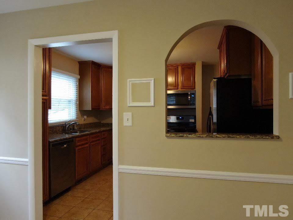 4703 Latimer Road Raleigh, NC 27609 - Photo 17 of 22 a view of a cabinet and a mirror in a room