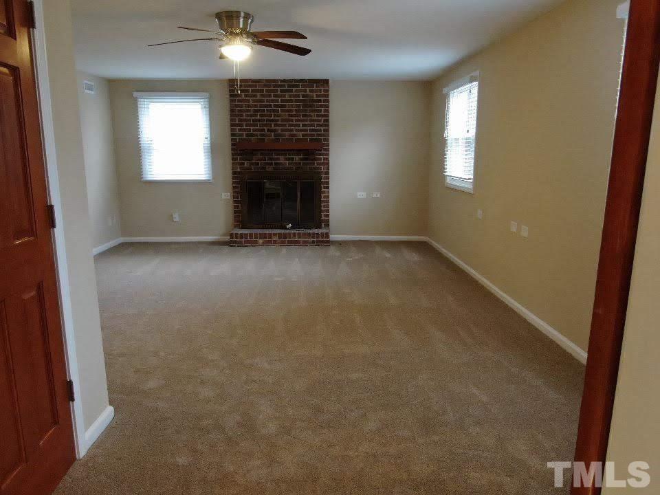 4703 Latimer Road Raleigh, NC 27609 - Photo 19 of 22 en empty room with windows and fireplace
