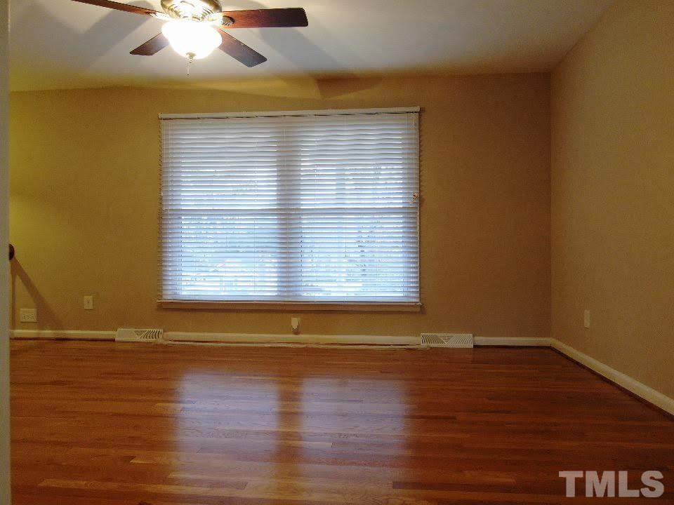 4703 Latimer Road Raleigh, NC 27609 - Photo 3 of 22 a view of empty room with wooden floor and fan