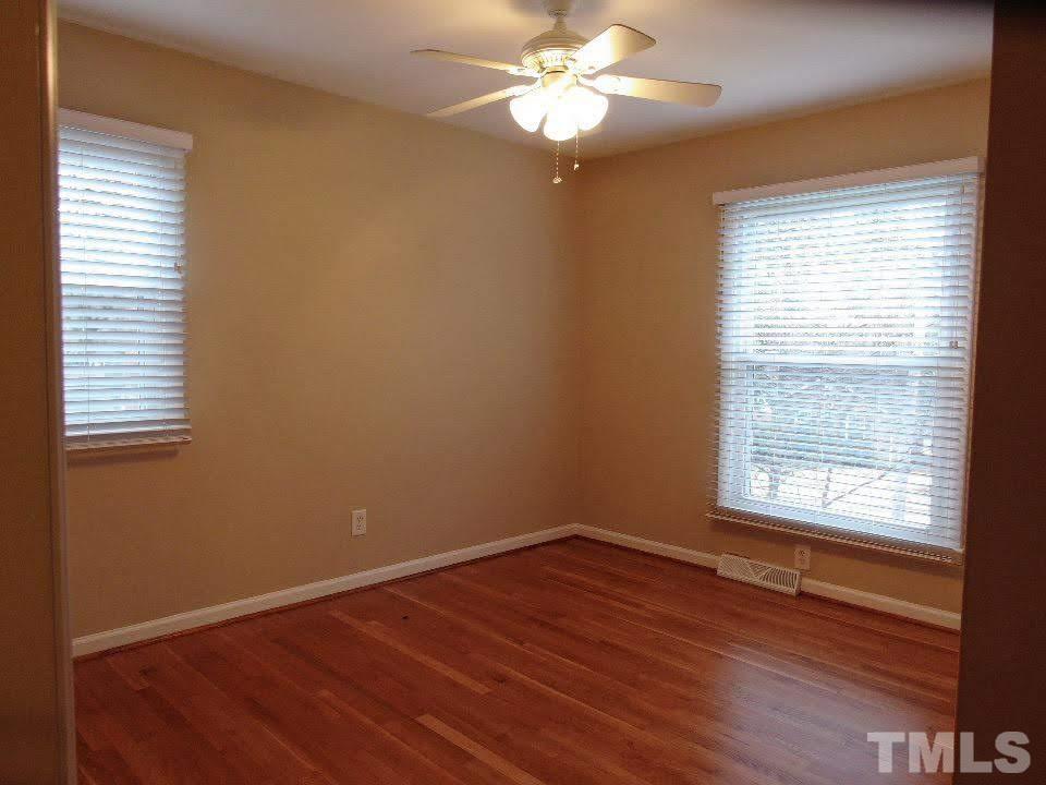 4703 Latimer Road Raleigh, NC 27609 - Photo 8 of 22 a view of an empty room with wooden floor and a window