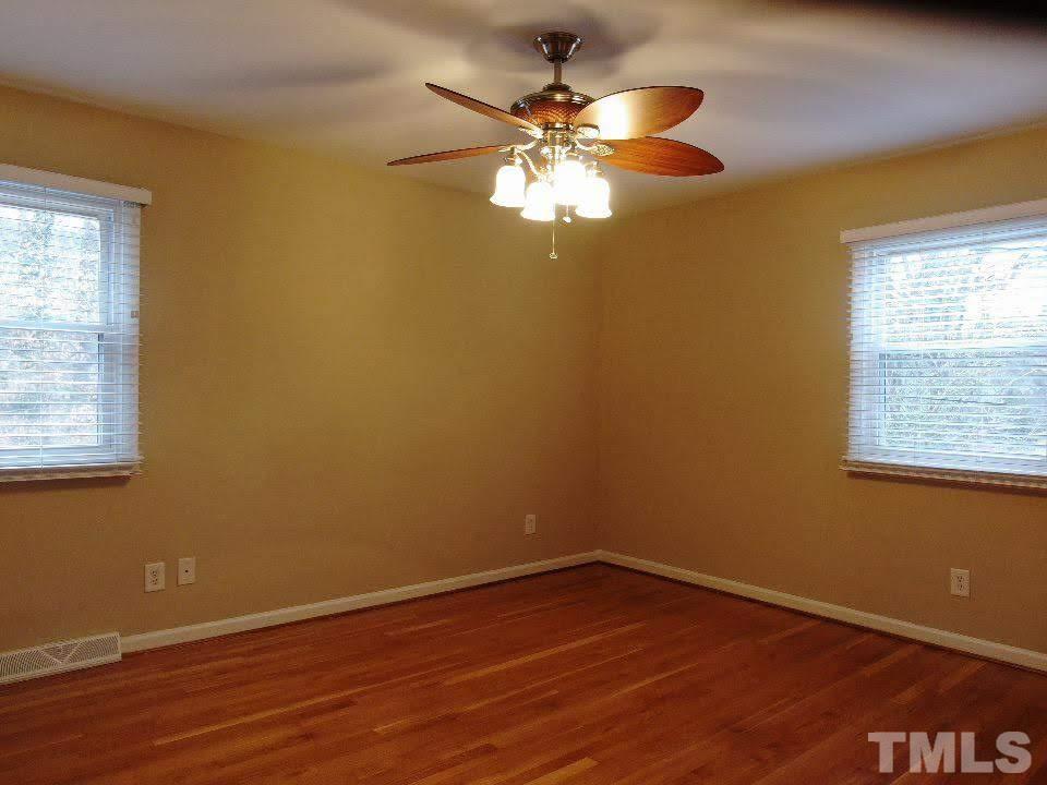 4703 Latimer Road Raleigh, NC 27609 - Photo 9 of 22 a view of a room with wooden floor and fan