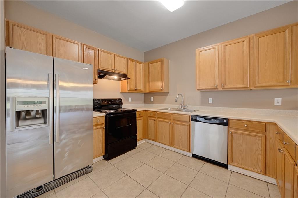 4203 Legacy Square Atlanta, GA 30349 - Photo 16 of 35 a kitchen with cabinets and stainless steel appliances