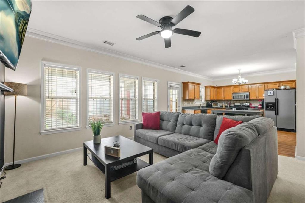 535 Anglewood Trace Stockbridge, GA 30281 - Photo 19 of 73 a living room with furniture ceiling fan and a window