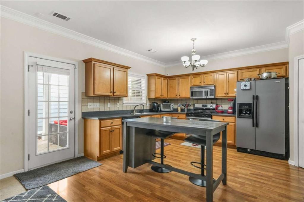 535 Anglewood Trace Stockbridge, GA 30281 - Photo 20 of 73 a kitchen with refrigerator cabinets and wooden floor