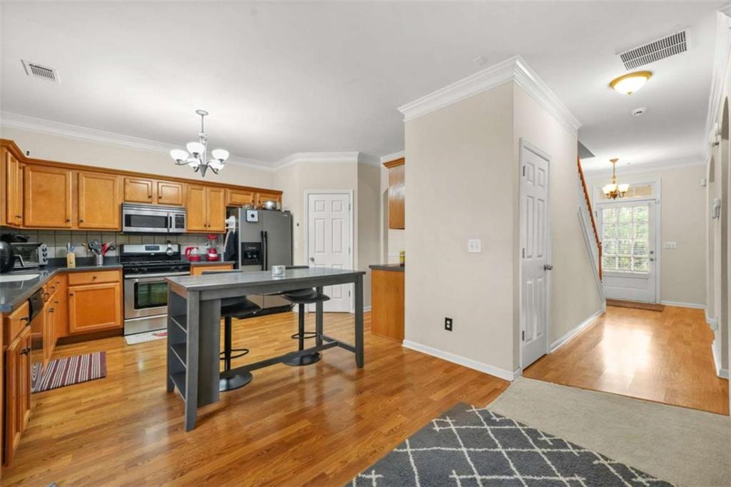 535 Anglewood Trace Stockbridge, GA 30281 - Photo 22 of 73 a kitchen with stainless steel appliances granite countertop a refrigerator and a stove top oven