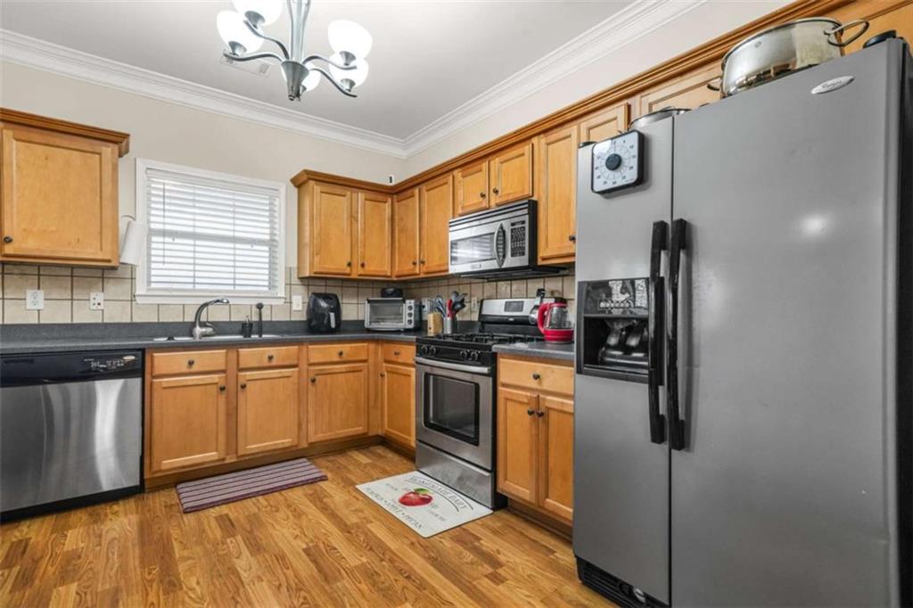 535 Anglewood Trace Stockbridge, GA 30281 - Photo 24 of 73 a kitchen with stainless steel appliances granite countertop a sink a stove and refrigerator