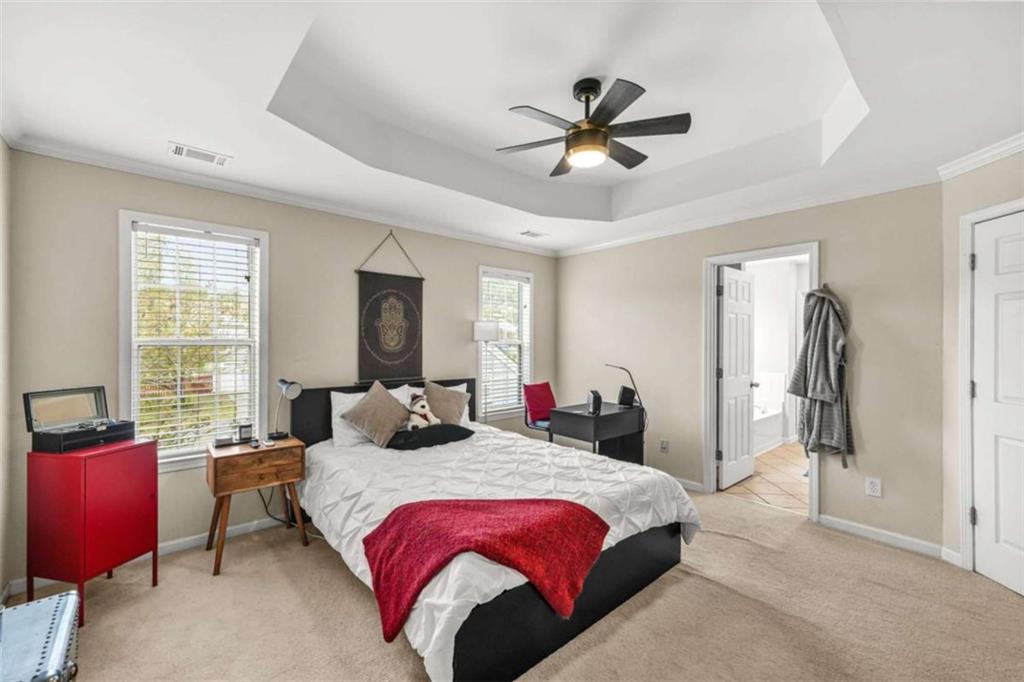 535 Anglewood Trace Stockbridge, GA 30281 - Photo 28 of 73 a bedroom with a bed a chandelier and a window