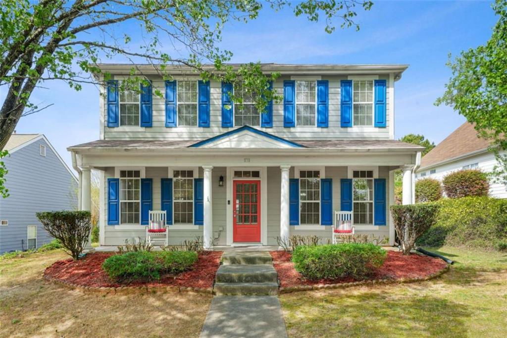 535 Anglewood Trace Stockbridge, GA 30281 - Photo 3 of 73 a view of a white house with large windows and a table and chairs in a yard
