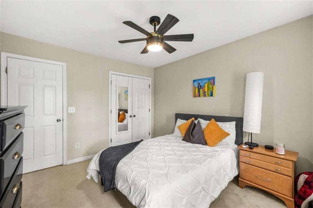 535 Anglewood Trace Stockbridge, GA 30281 - Photo 35 of 73 a bedroom with a bed and a ceiling fan