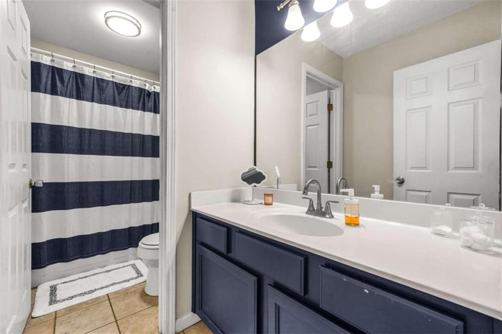 535 Anglewood Trace Stockbridge, GA 30281 - Photo 37 of 73 a bathroom with a sink a toilet a shower and a mirror