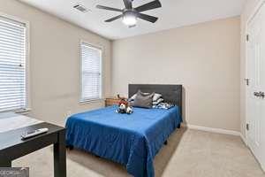 535 Anglewood Trace Stockbridge, GA 30281 - Photo 38 of 73 a bedroom with a bed and two windows
