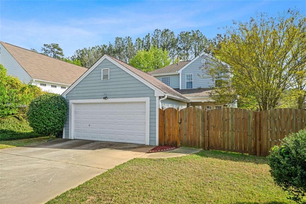 535 Anglewood Trace Stockbridge, GA 30281 - Photo 56 of 73 a front view of a house with a yard and garage