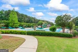 535 Anglewood Trace Stockbridge, GA 30281 - Photo 65 of 73 a view of a garden with a building in the background